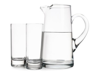 Photo of Jug with water and empty glasses on white background