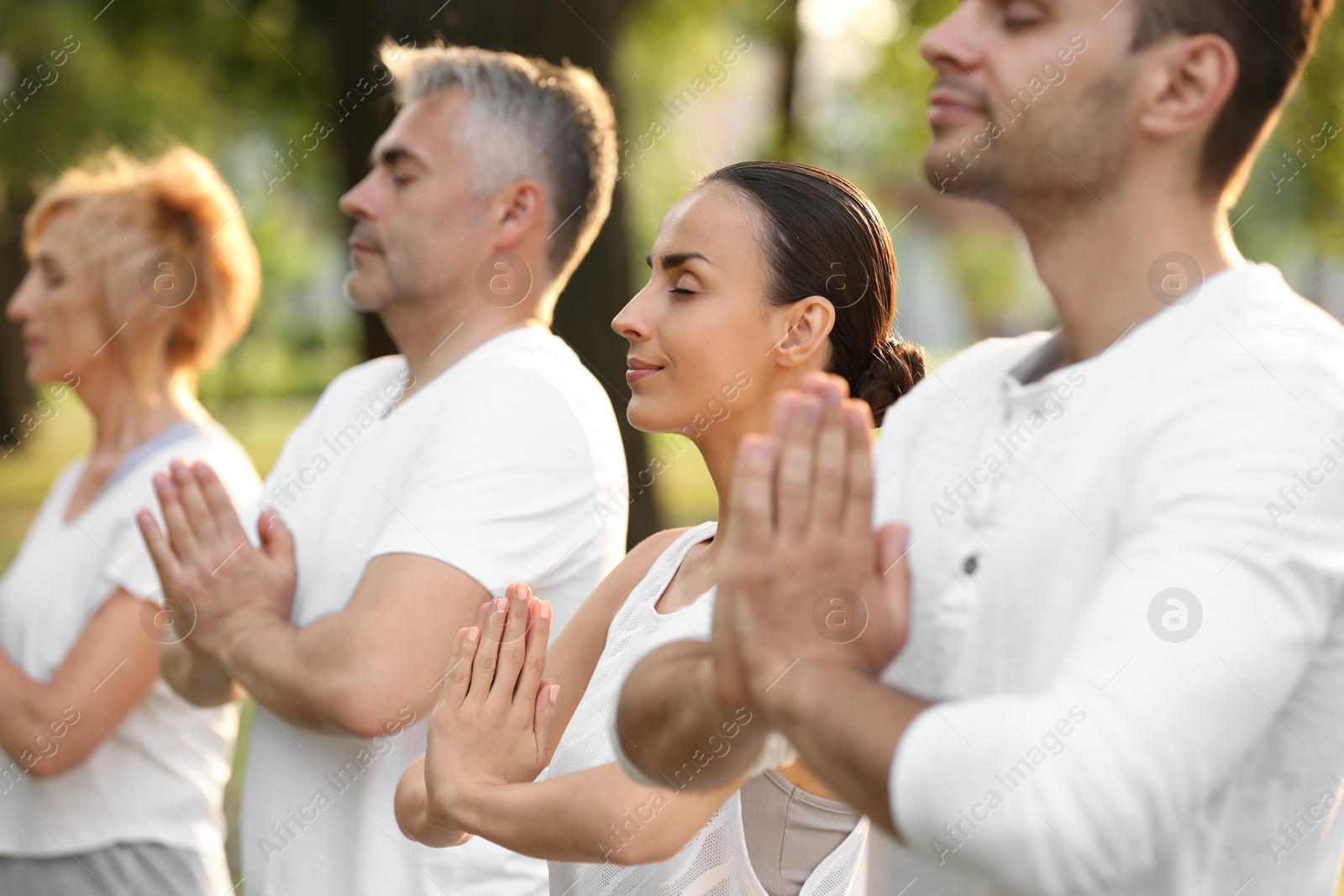 Photo of People practicing yoga in park at morning