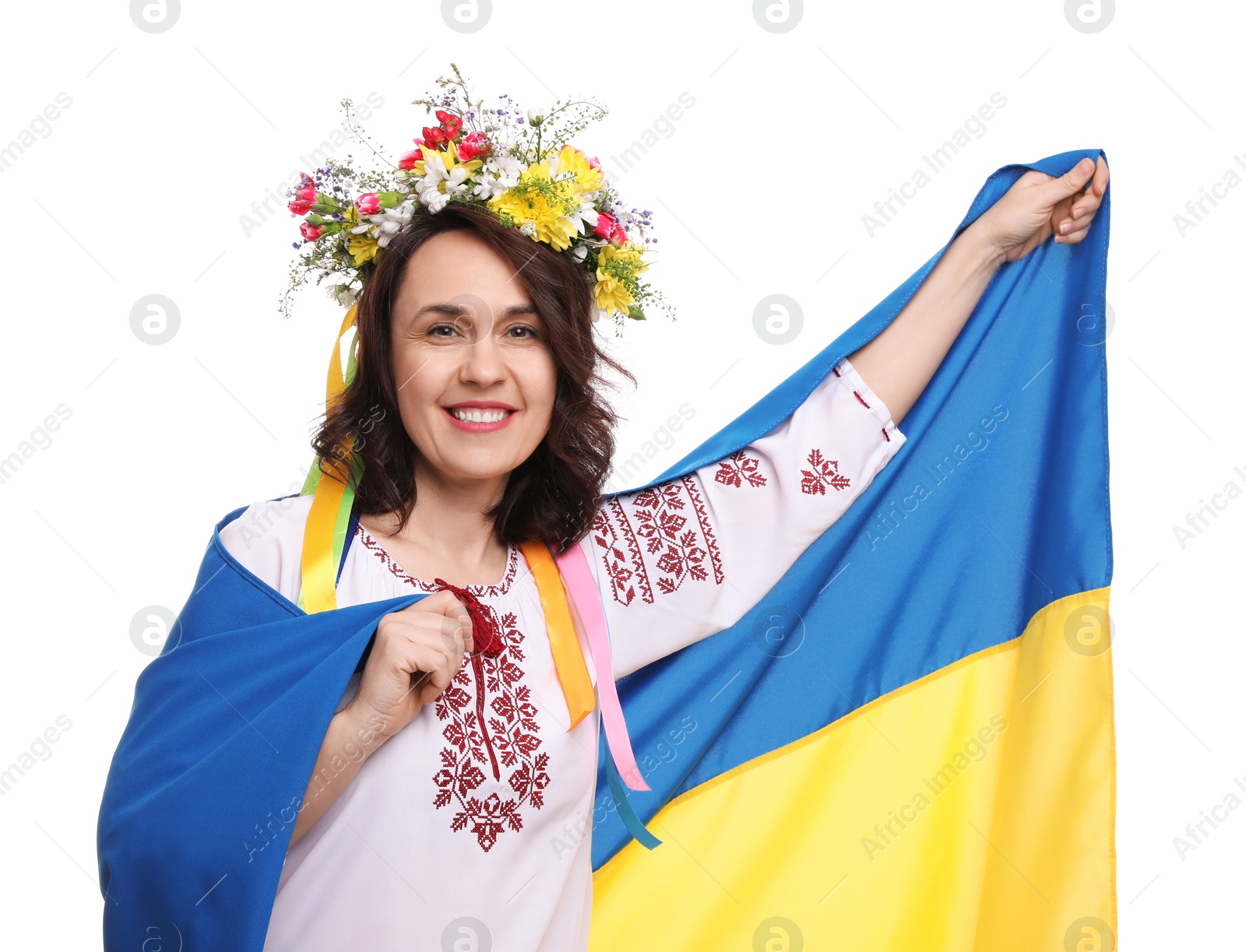 Photo of Happy woman in national clothes with flag of Ukraine on white background