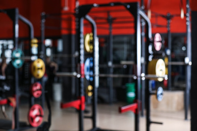 Photo of Blurred view of gym with modern equipment