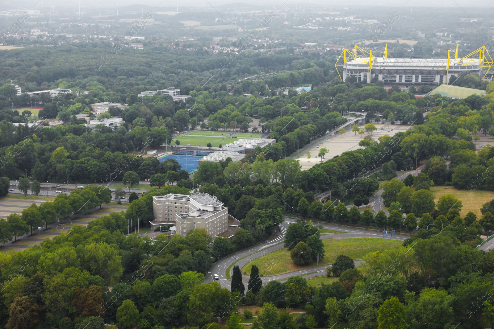 Photo of Beautiful view of city with buildings, roads and green trees