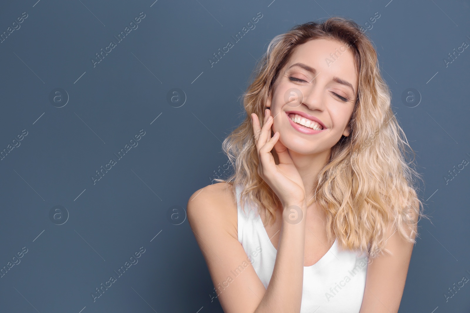 Photo of Young woman with beautiful smile on color background. Teeth whitening