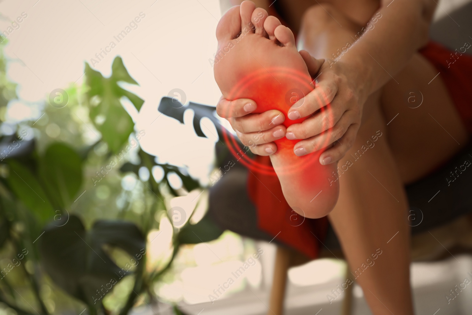 Image of Woman suffering from foot pain at home, closeup. Space for text