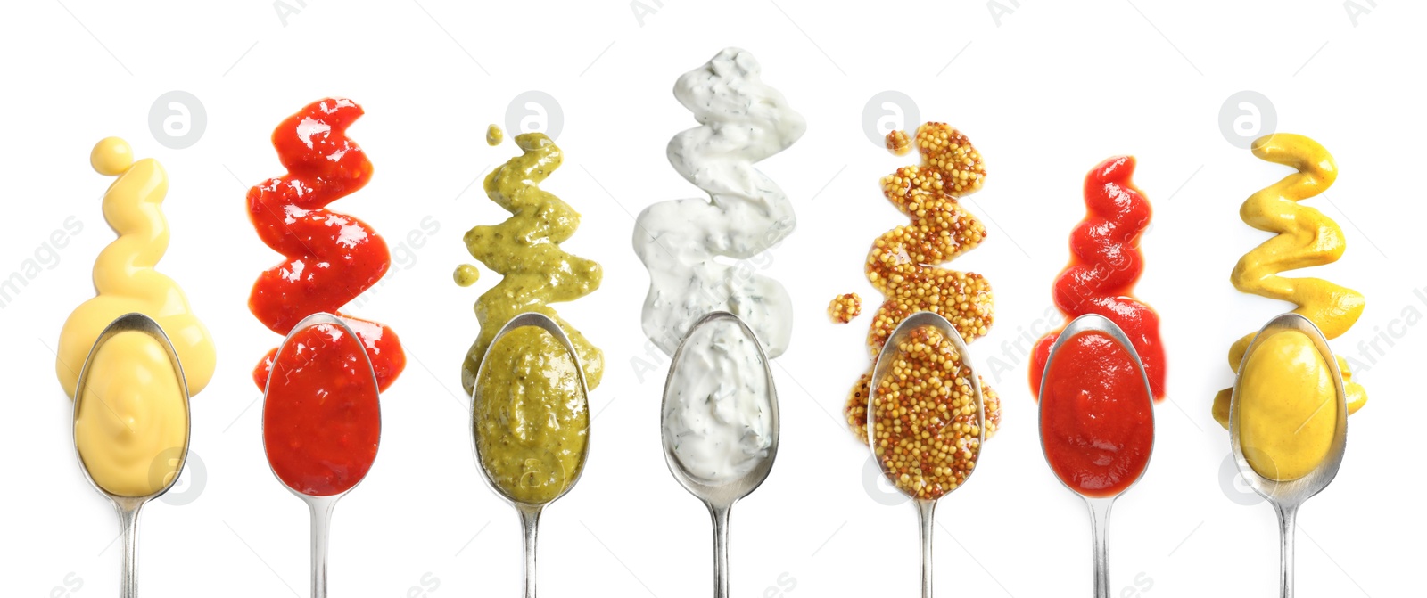 Image of Set of spoons with different delicious sauces on white background, top view. Banner design