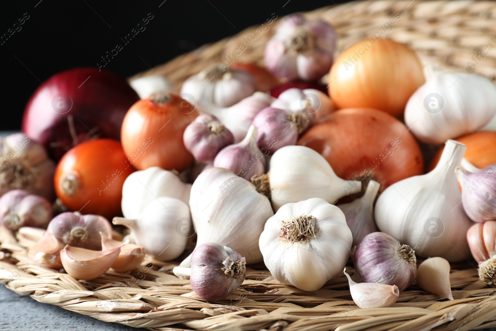 Photo of Fresh raw garlic and onions on table, closeup