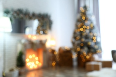 Photo of Blurred view of stylish interior with decorated Christmas tree and fireplace