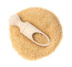 Pile of brown sugar and wooden scoop isolated on white, top view