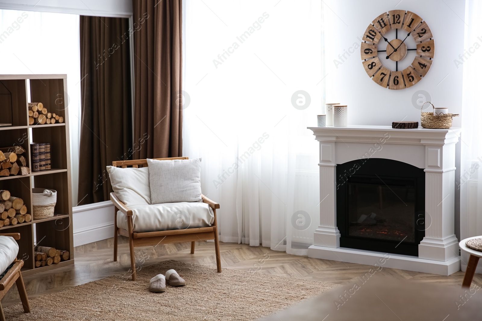 Photo of Elegant artificial fireplace and armchair in room. Interior design