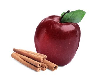 Image of Aromatic cinnamon sticks and red apple isolated on white