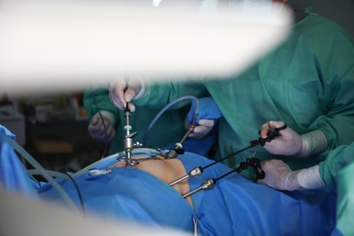 Medical team performing surgery in operating room, closeup