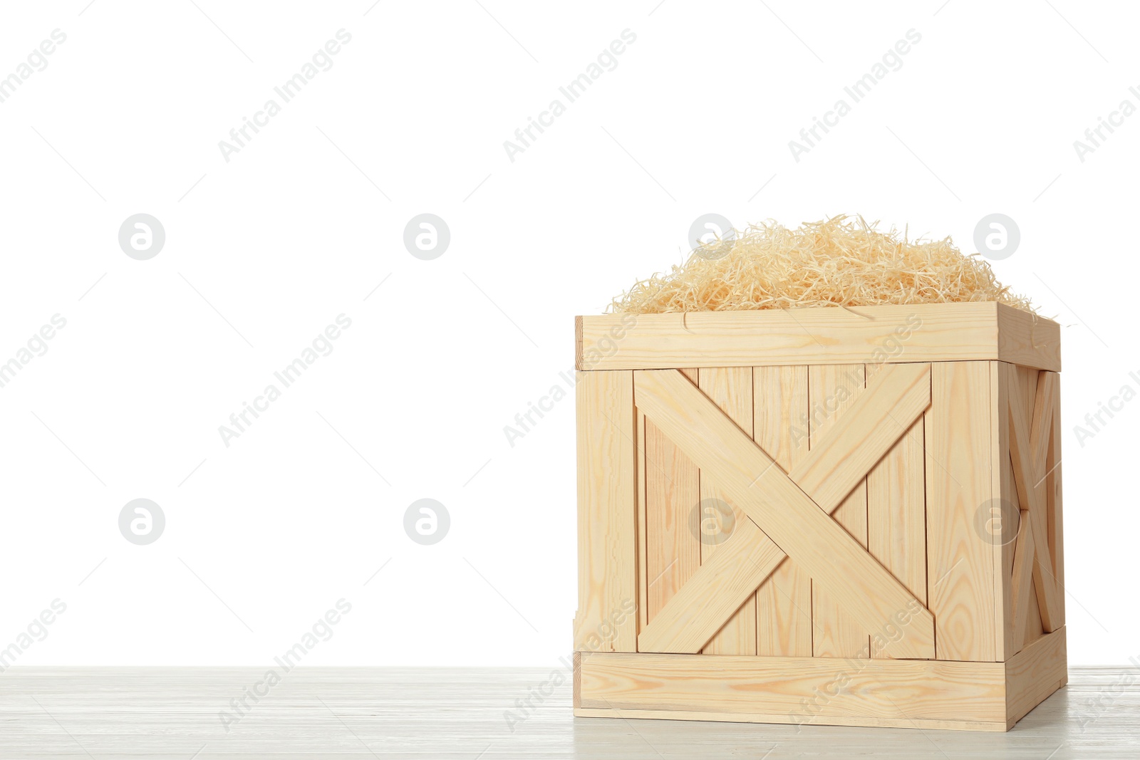 Photo of Wooden crate on table against white background. Space for text