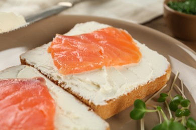 Photo of Delicious sandwiches with cream cheese and salmon on plate, closeup