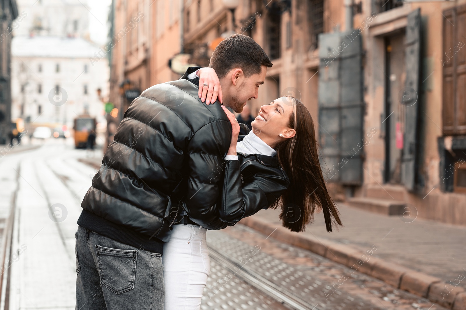 Photo of Lovely young couple walking together on city street. Romantic date