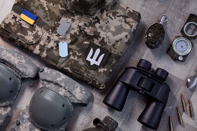 Photo of MYKOLAIV, UKRAINE - SEPTEMBER 19, 2020: Flat lay composition with Ukraine military outfit and equipment on floor