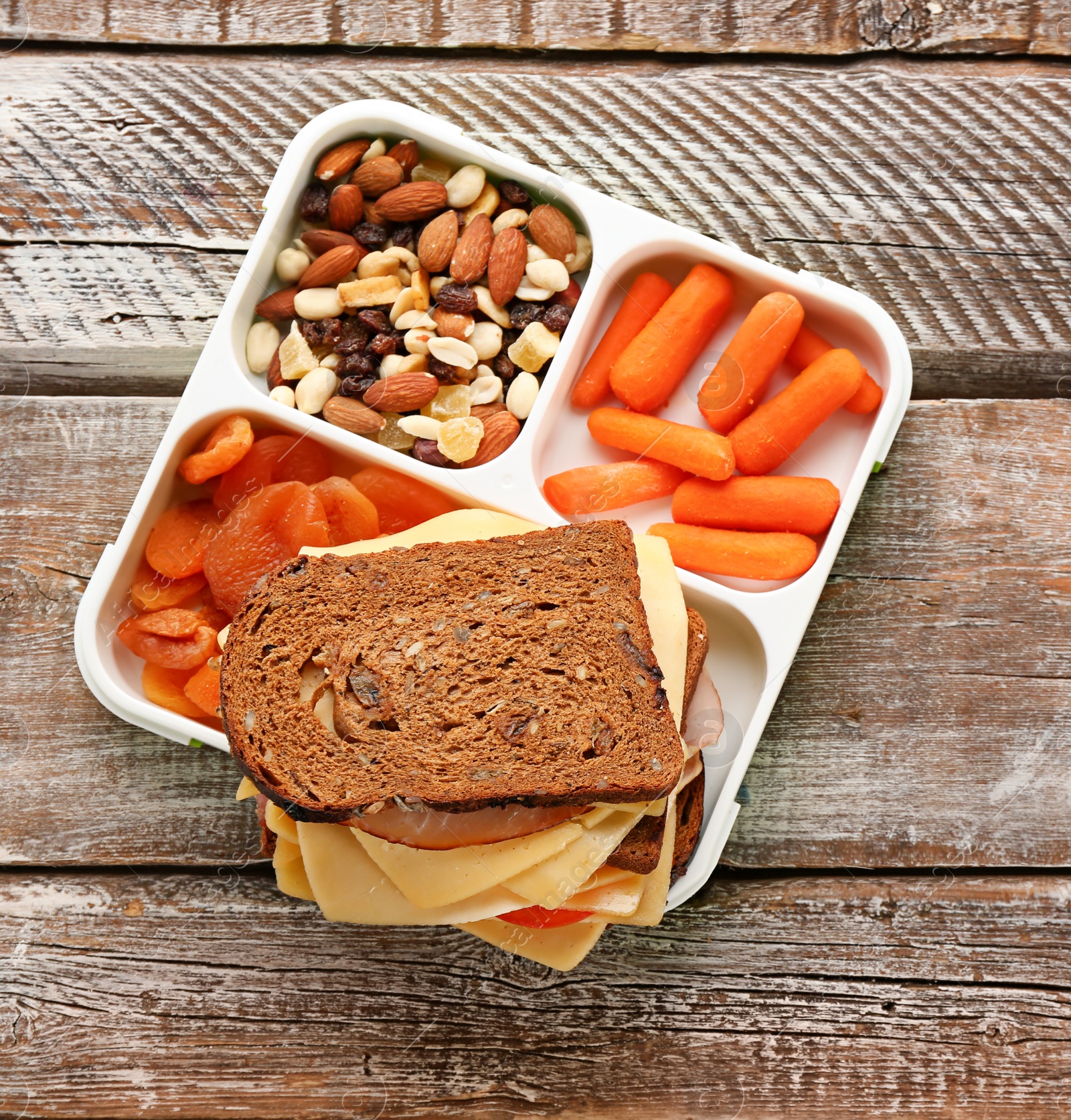 Photo of Lunch box with tasty food on wooden background