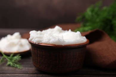 Delicious pork lard in bowl on wooden table, closeup