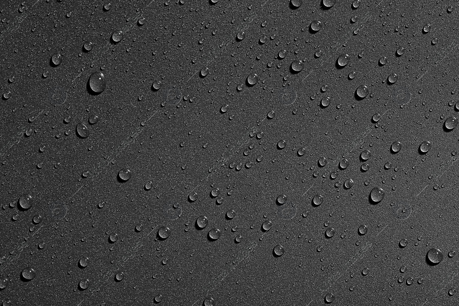 Photo of Water drops on black background, top view