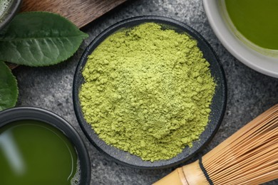 Flat lay composition with green matcha powder on grey table