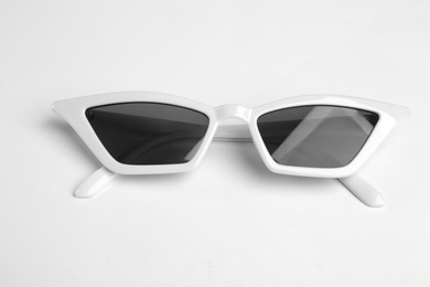 Photo of Stylish sunglasses on white background. Fashionable accessory