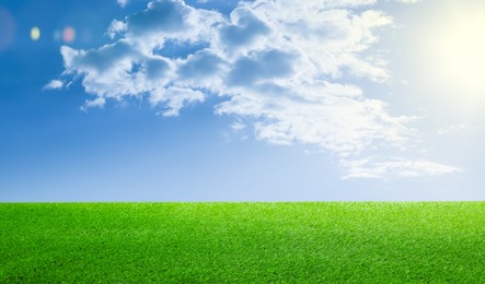 Image of Green grass under blue sky with clouds, banner design