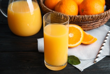 Photo of Composition with orange juice and fresh fruit on wooden background