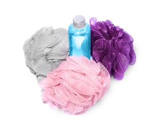 Photo of New shower puffs and bottle of cosmetic product on white background