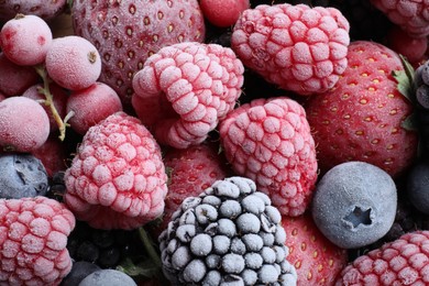 Photo of Mix of different frozen berries as background, top view