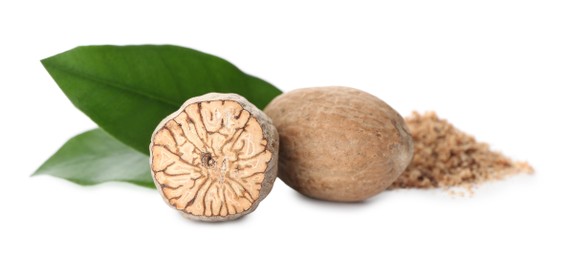 Photo of Grated nutmeg and seeds with green leaves on white background
