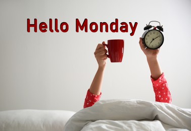 Image of Hello Monday, start your week with good mood. Closeup view of woman with cup and alarm clock lying in bed