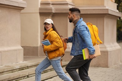 Being late. Students running towards building outdoors