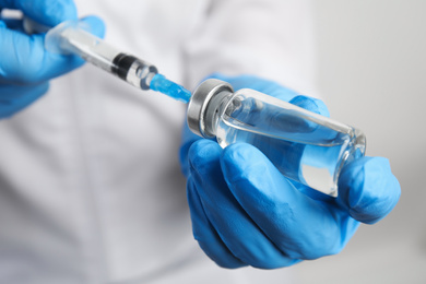 Photo of Doctor filling syringe with medication, closeup. Vaccination and immunization