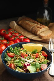 Photo of Delicious salad with lentils and vegetables served on wooden table