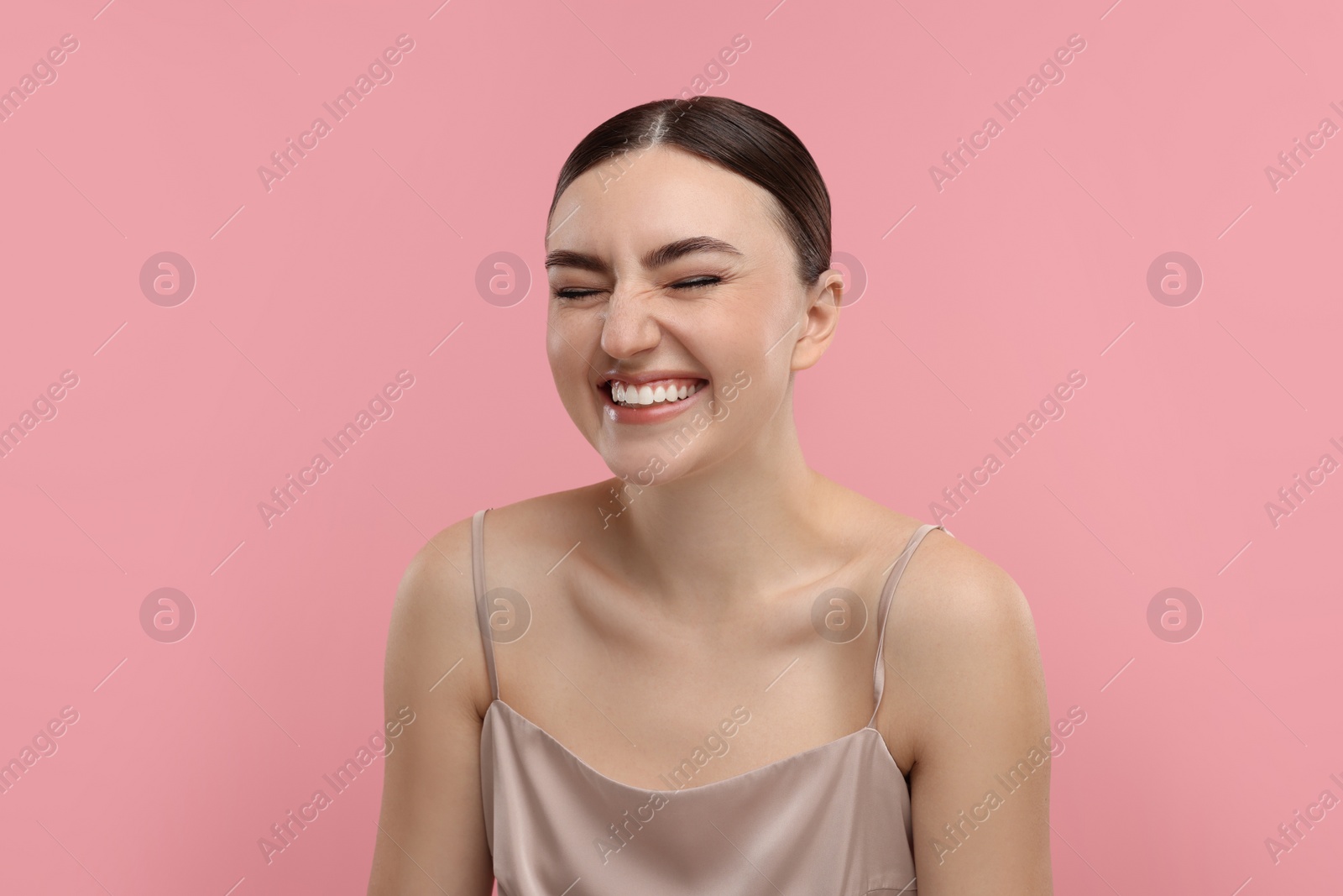 Photo of Portrait of beautiful woman laughing on pink background