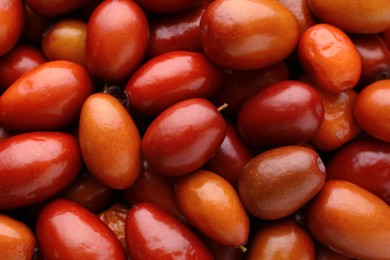 Photo of Heap of ripe red dates as background, closeup