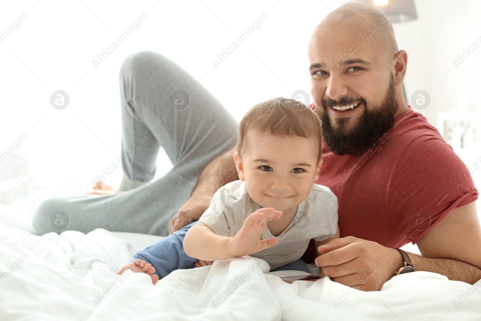 Photo of Dad and his little son spending time together at home