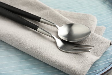 Photo of Stylish setting with cutlery, napkin and plate on table, closeup