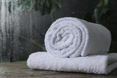 Photo of White terry towels on table in bathroom, space for text