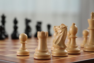 Photo of White wooden pieces on chess board, selective focus. Space for text