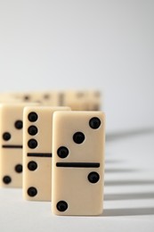 Photo of Domino tiles on white background. Space for text