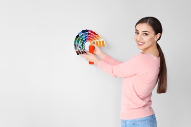 Photo of Young woman with color palette on white background