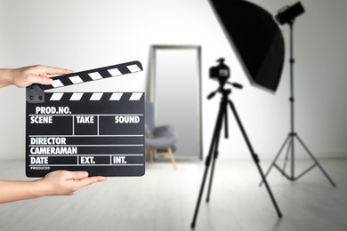 Image of Assistant holding clapperboard on filming location, closeup. Cinema production 