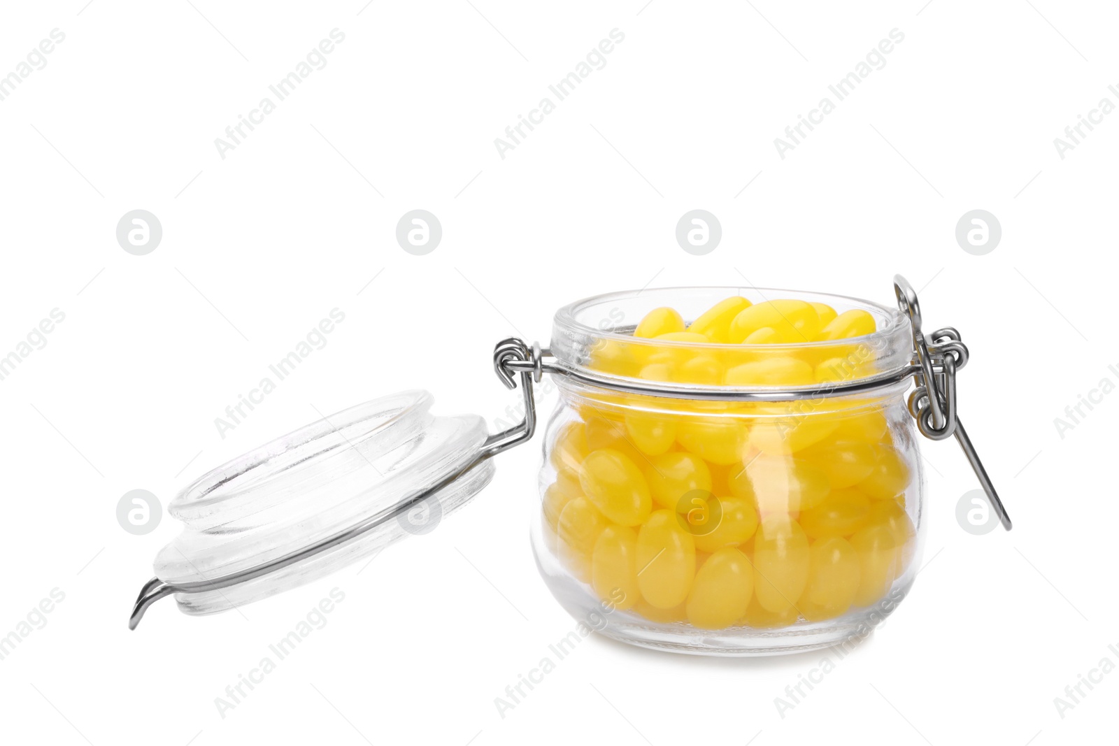 Tasty small lemon drops in glass jar isolated on white Photo of Tasty small lemon drops in glass jar isolated on white