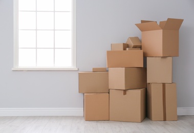 Photo of Cardboard boxes on floor indoors