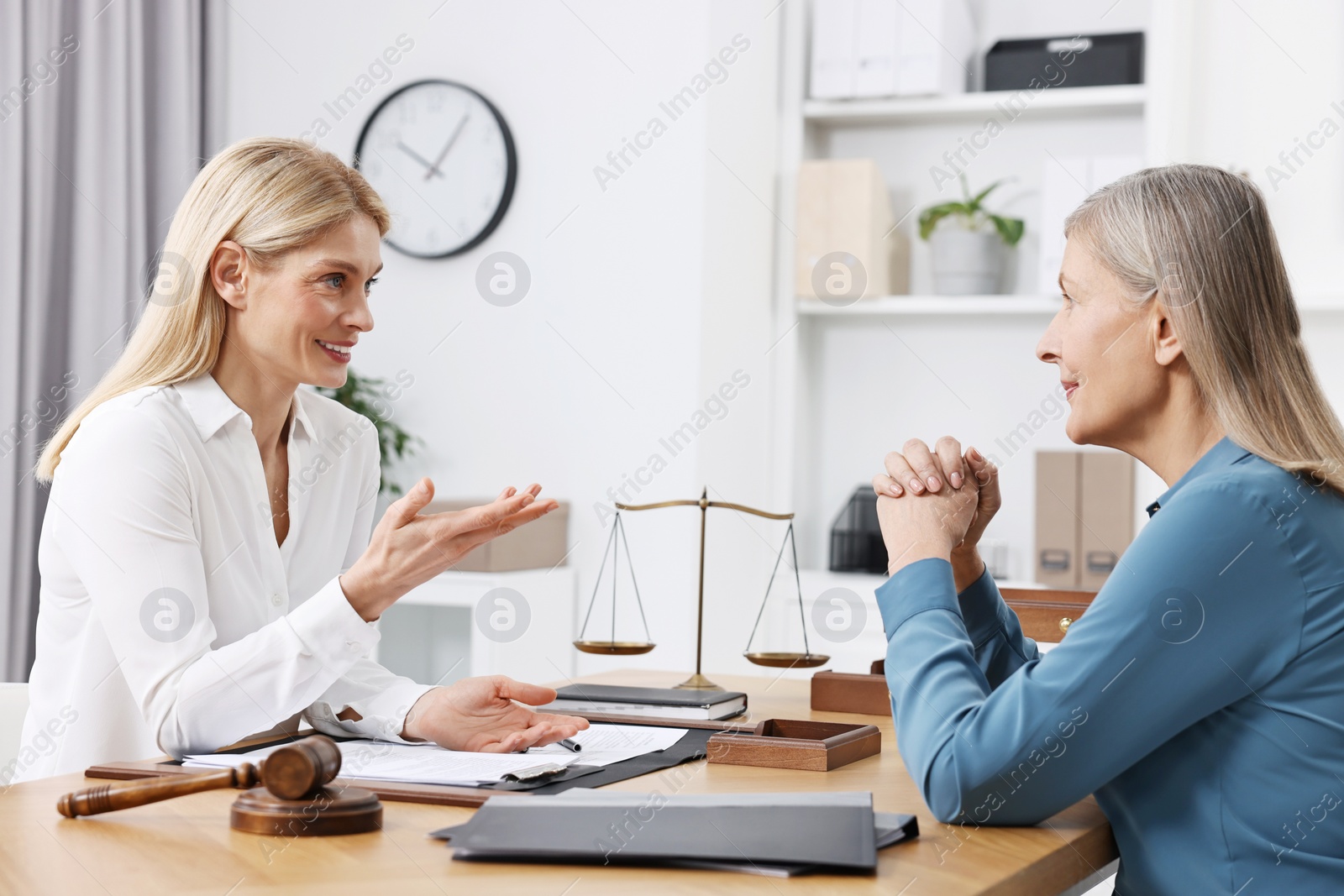 Photo of Senior woman having meeting with lawyer in office