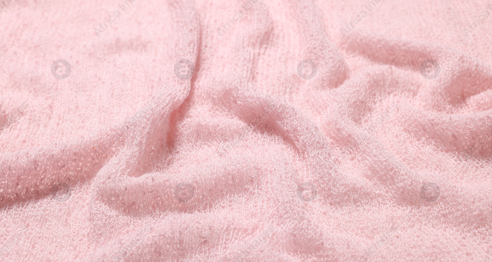 Photo of Texture of soft pink crumpled fabric as background, closeup