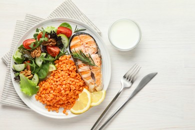Photo of Plate with healthy food high in vegetable fats served on light wooden table, flat lay. Space for text