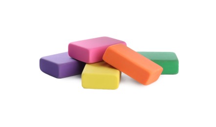 Photo of Pile of bright erasers on white background