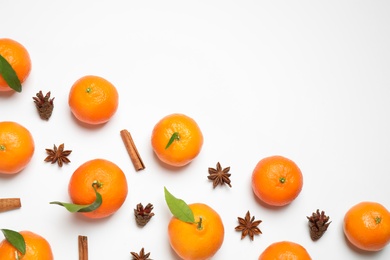 Photo of Christmas composition with tangerines on white background, flat lay. Space for text