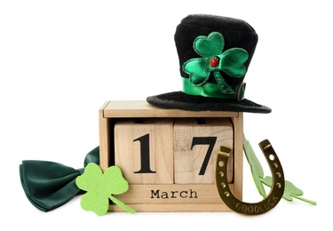 Photo of Leprechaun's hat, block calendar and St. Patrick's day decor on white background