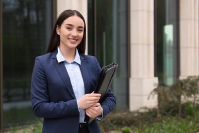 Real estate agent with leather portfolio outdoors. Space for text